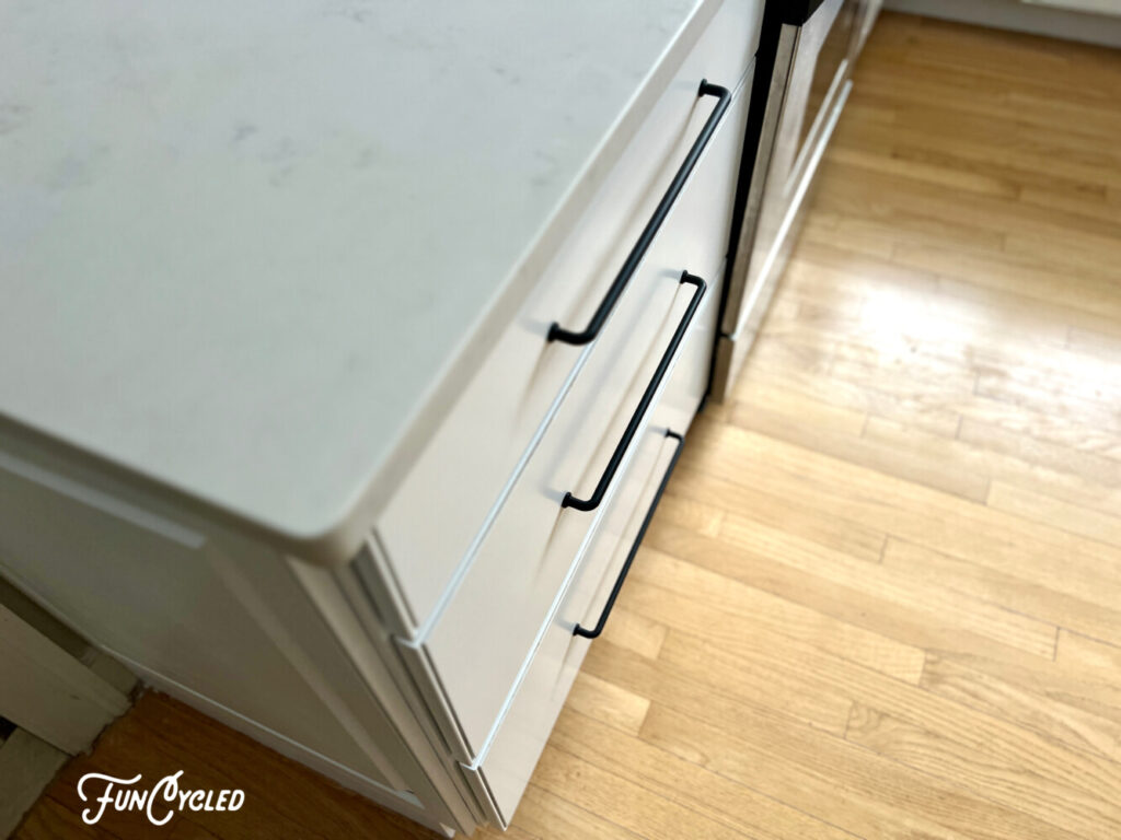 long black cabinet pull on white cabinets 