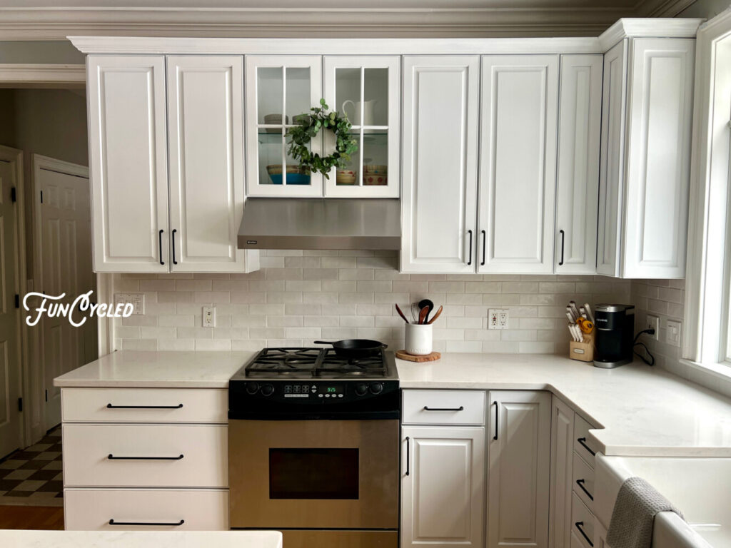 White kitchen cabinets with quartz counter and subway tile