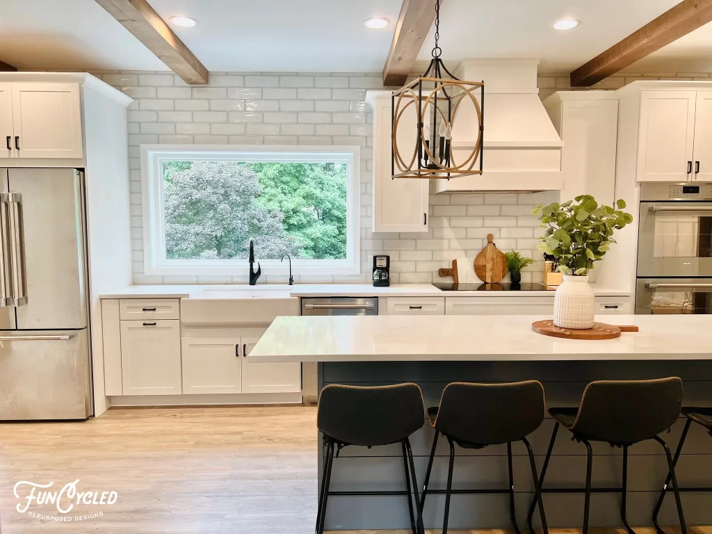 Kitchen with white subway tile painted white cabinets